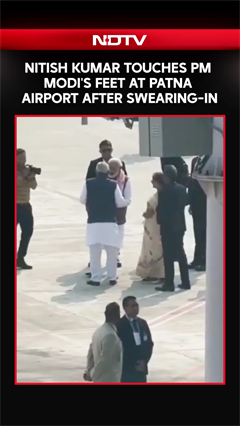 Nitish Kumar Touches PM Modi's Feet At Patna Airport After Swearing-In