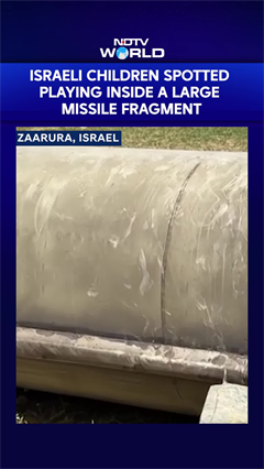 Israeli Children Spotted Playing Inside A Large Missile Fragment