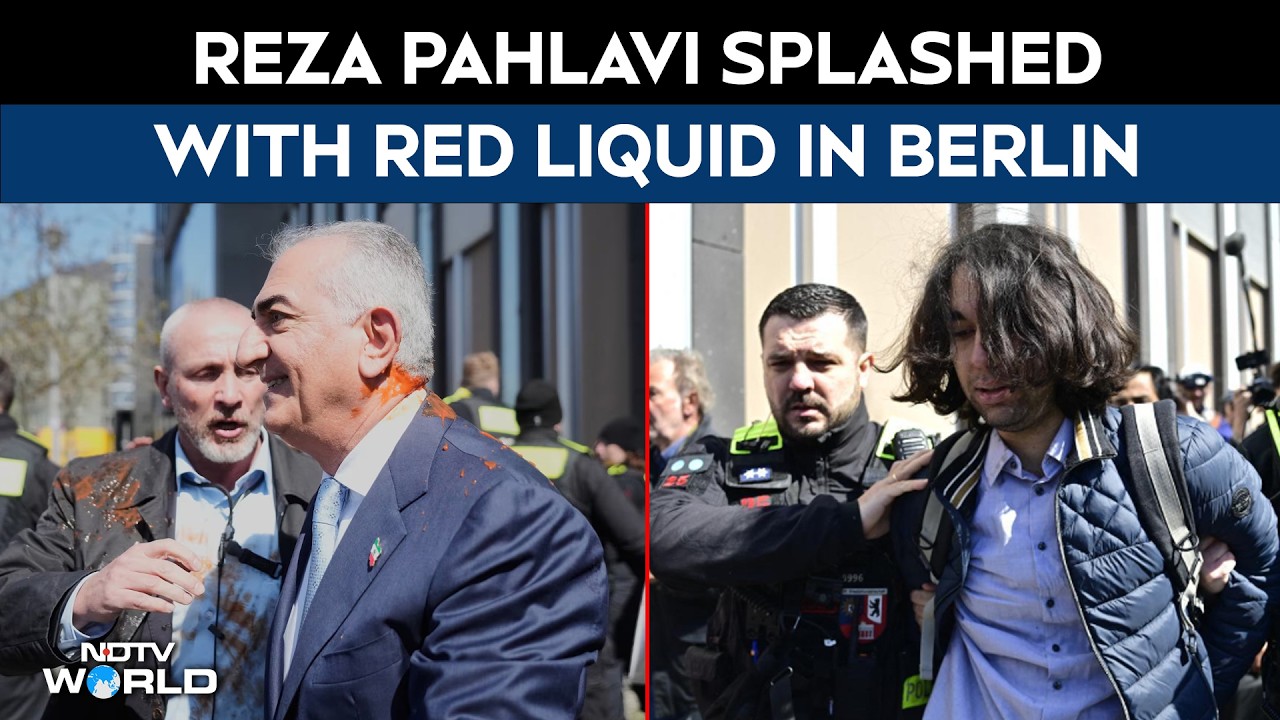 US Iran War | Reza Pahlavi Splashed With Red Liquid in Berlin, Dramatic Protest Caught on Camera