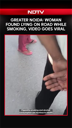 Viral Video: Woman Lies In Middle Of Road Smoking In Greater Noida