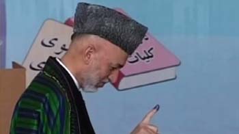 Afghans vote amid threats and scattered attacks