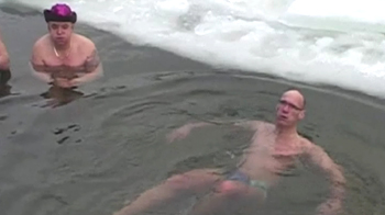 Germans brave New Year chill, swim in ice covered lake