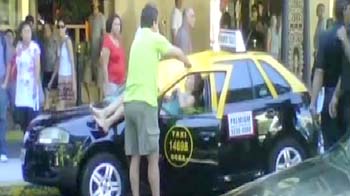 Woman jumps from roof, hits taxi and survives