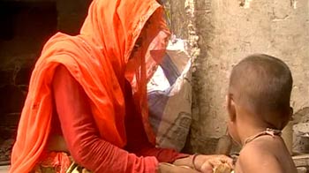 Carrying a child and burden of water Carrying a child and burden of water