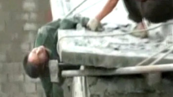 Dramatic rescue of man dangling from 3-storey building