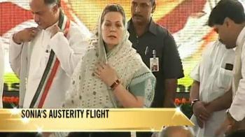Sonia flies economy, Rahul to take train